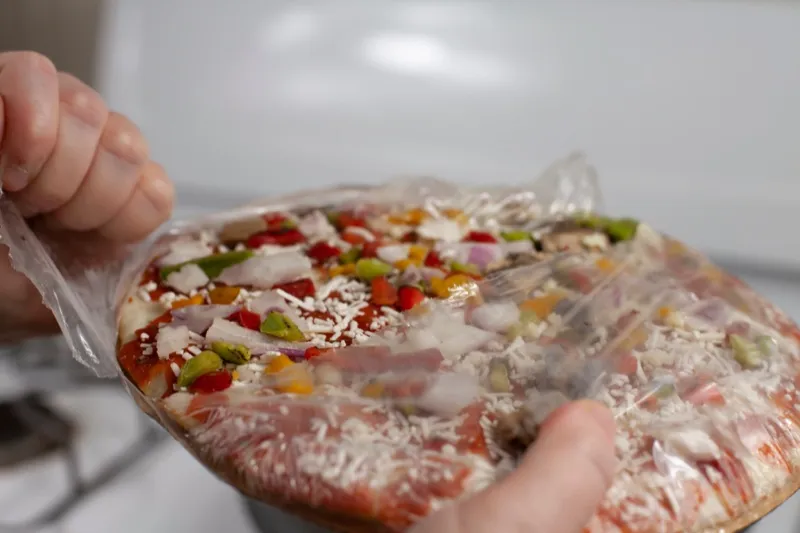 A frozen pizza in its wrapper