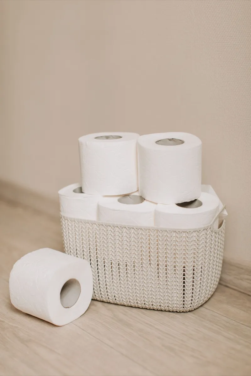 Rolls of toilet paper in a white basket